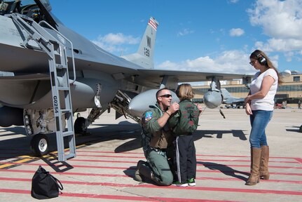 Maj. Gregory “Amp” Gossner, a pilot with the 120th Fighter Squadron, 140th Wing, Colorado Air National Guard, says goodbye to his loved ones as he prepares to deploy to Kadena Air Base, Japan, for the Theater Security Package. 