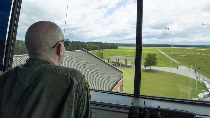 Leon Logothetis, TV personality and author of The Kindness Diaries, watches as a C-17 Globemaster III drops a cargo load during his visit to Joint Base Charleston, S.C., May 5, 2017. Logothetis flew with the 14th Airlift Squadron to receive a firsthand look at the mission of the 437th Airlift Wing and Air Mobility Command.