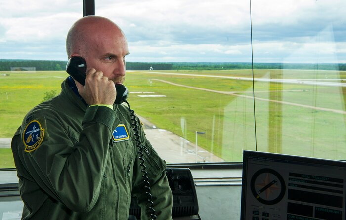 Leon Logothetis, TV personality and author of The Kindness Diaries, talks on the phone with C-17 Globemaster III pilots during his visit to Joint Base Charleston, S.C., May 5, 2017. Logothetis toured the base and received demonstrations from different squadrons.