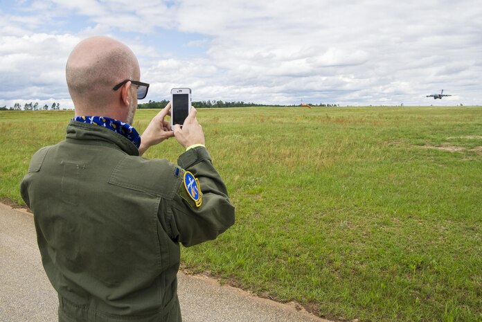 Leon Logothetis, TV personality and author of The Kindness Diaries, photographs a C-17 Globemaster III as it lands during his visit to Joint Base Charleston, S.C., May 5, 2017. Logothetis flew with the 14th Airlift Squadron to receive a firsthand look at the mission of the 437th Airlift Wing and Air Mobility Command. Additionally he was able to observe a C-17 drop a cargo load and demonstrate a combat landing. 