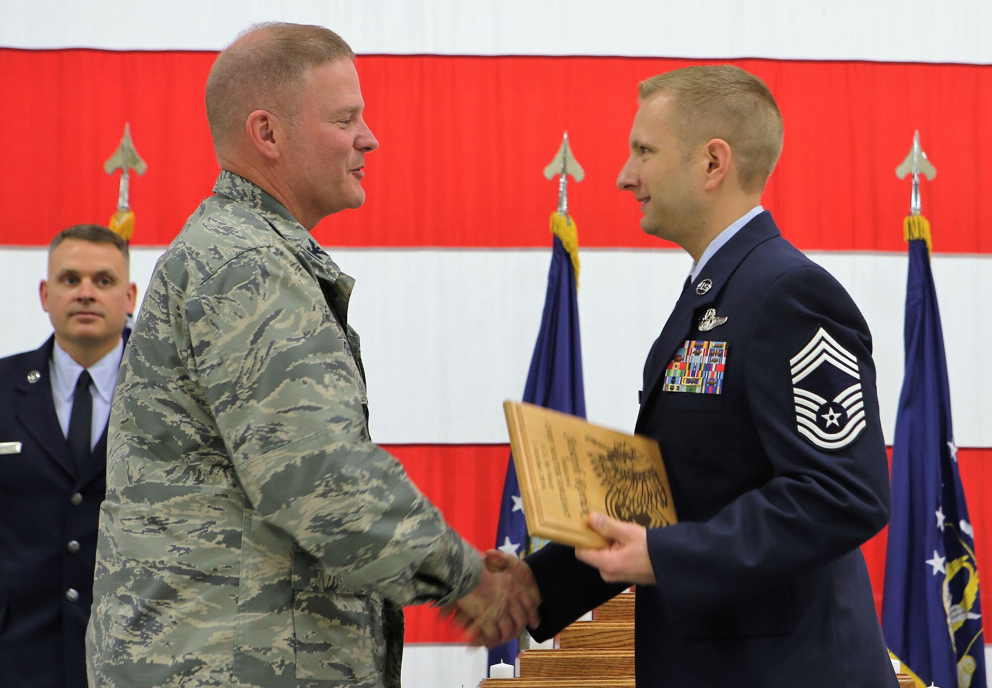 Chief Master Sgt. Joseph Rorick shakes hands with Col. James DeVere, 302nd Airlift Wing commander, after accepting a recognition plaque during the Reserve wing’s Chief Induction Ceremony at Peterson Air Force Base, Colo., May 6, 2017. Four newly-promoted chief master sergeants within the 302nd AW were recognized during the ceremony, ensuring the lineage and historical significance of the Air Force's top enlisted rank was on display for those in attendance. Rorick is assigned to the 302nd Operations Support Squadron. Also recognized during the ceremony were Chief Master Sgts. Jonathan Shaw, 39th Aerial Port Squadron, Kenneth Kunkel, 731st Airlift Squadron, and Lawrence Prieto, 302nd Logistics Readiness Squadron. (U.S. Air Force photo/1st Lt. Stephen J. Collier)