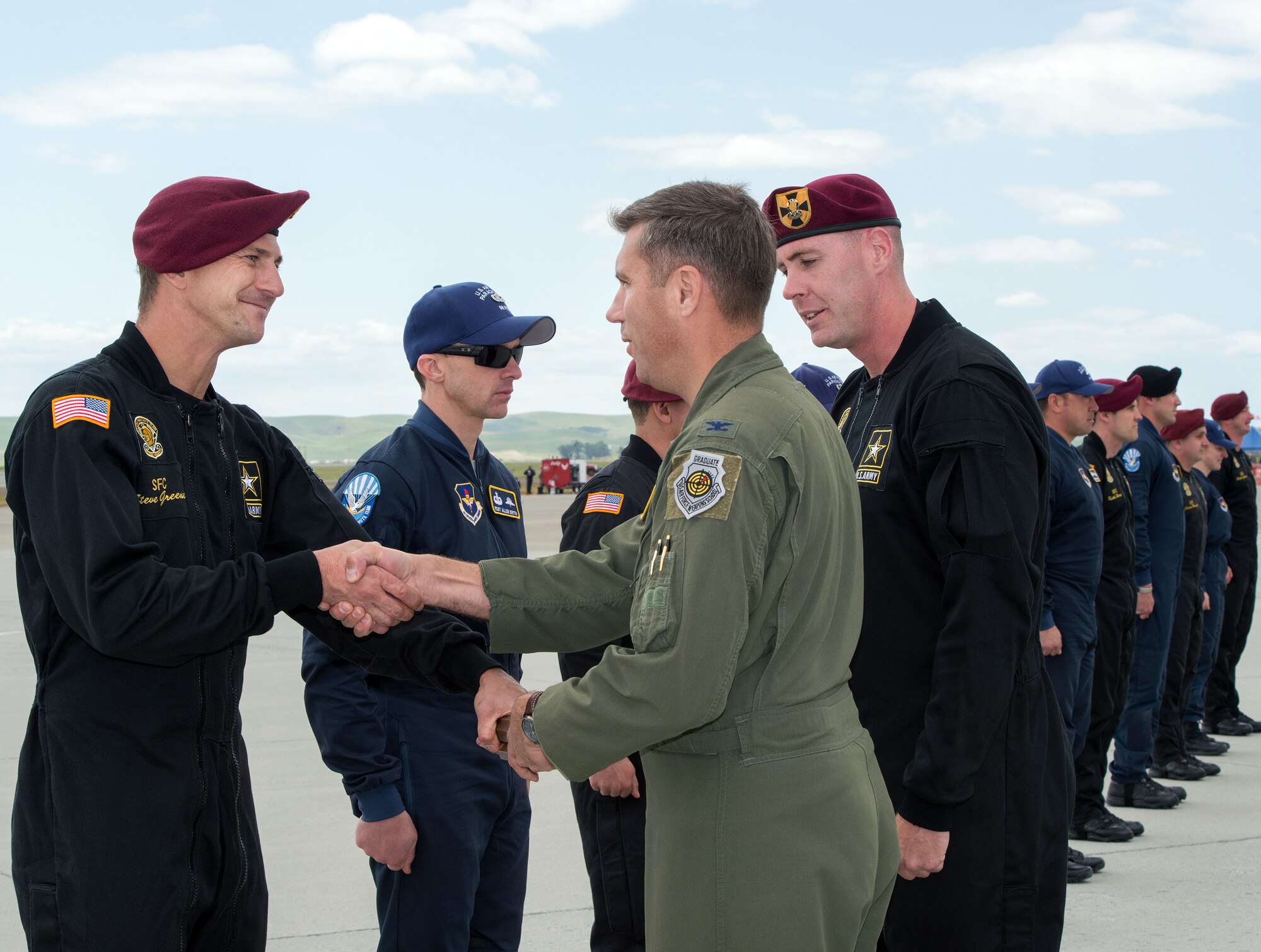 U.S. Air Force Col. John Klein, 60th Air Mobility Wing commander, receives a baton from the U.S. Army Golden Knights parachute team during the Wings Over Solano Air Show at Travis Air Force Base, Calif., May 6, 2017. The two-day event featured performances by the Golden Knights, U.S. Air Force Thunderbirds, flyovers and static displays. (U.S. Air Force photo by Louis Briscese)