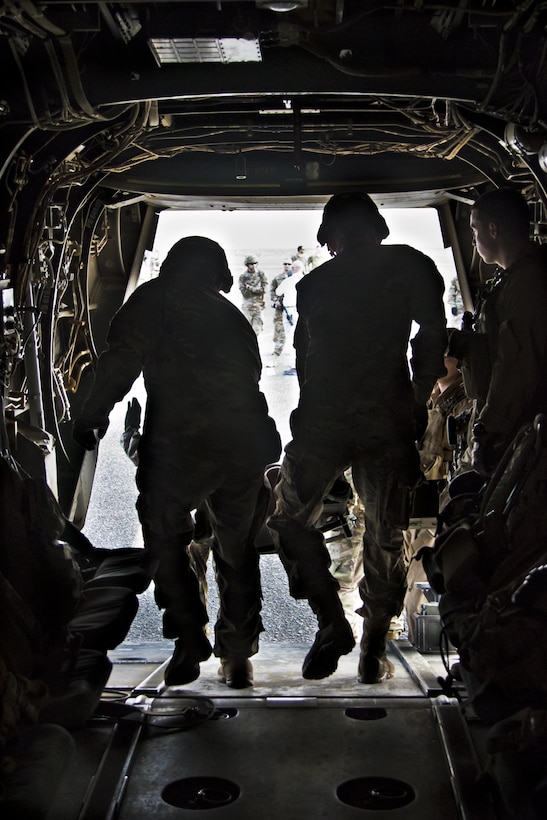 U.S. Army combat medics, with the 86th Combat Support Hospital, carry a simulated casualty off of a MV-22 Osprey during a joint training exercise with Marines from Marine Medium Tiltrotor Squadron - 364 (VMM-364), at Camp Arifjan, Kuwait, May 8, 2017. (U.S. Army photo by Staff Sgt. Dalton Smith)