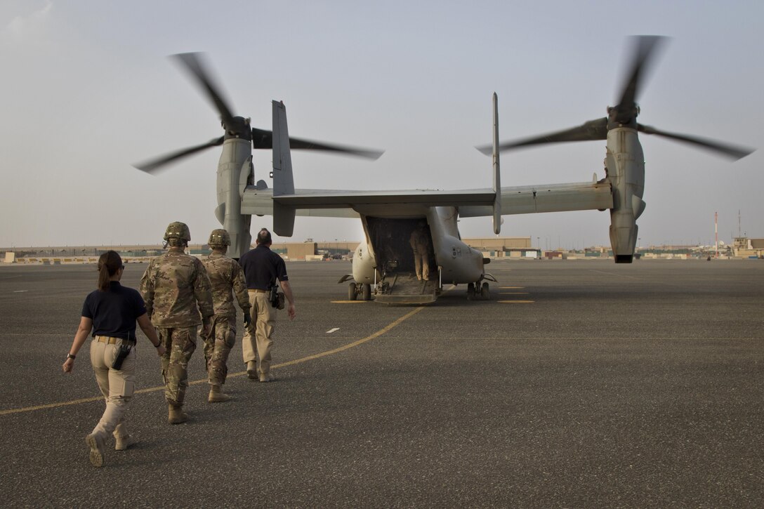 U.S. Army combat medics, with the 86th Combat Support Hospital, and Emergency Medical Technicians, with Area Support Group - Kuwait Joint Emergency Service, approach a MV-22 Osprey during a joint training exercise with Marines from Marine Medium Tiltrotor Squadron - 364 (VMM-364), at Camp Arifjan, Kuwait, May 8, 2017. (U.S. Army photo by Staff Sgt. Dalton Smith)