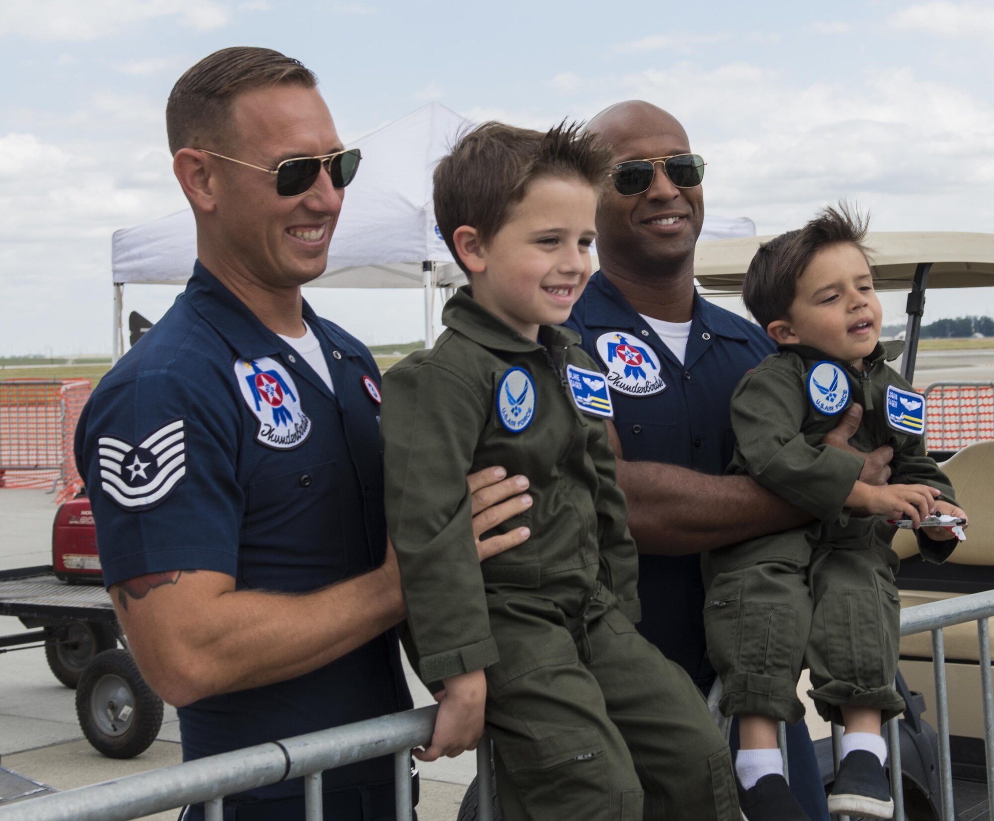 Members of the U.S. Air Force Thunderbirds pose for photos with children during the Wings Over Solano Air Show at Travis Air Force Base, Calif., May 6, 2017. The two-day event featured performances by the Thunderbirds, U.S. Army Golden Knights parachute team, flyovers and static displays. (U.S. Air Force photo by Heide Couch)
