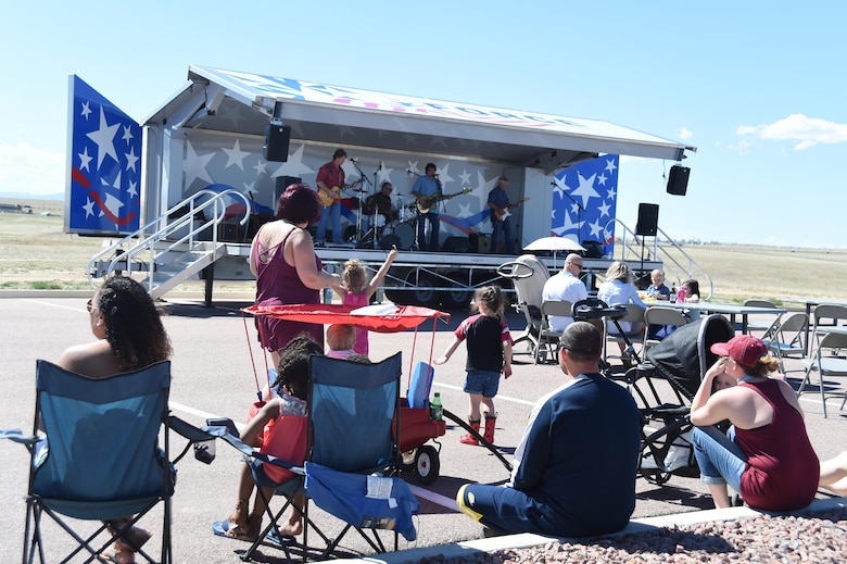 Schriever families congregate to watch “9’s a Pair” play during May’s First Friday concert at Schriever Air Force Base, Colorado, Friday, May 5, 2017. Thanks to the Force Support Squadron’s continued efforts to ramp up quality of life, Schriever personnel and their families are able to take part in events like First Friday. (U.S. Air Force photo/Senior Airman Arielle Vasquez)