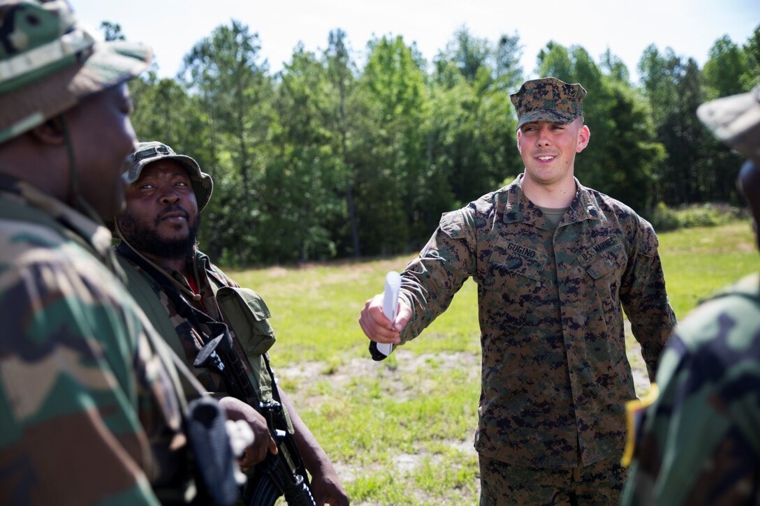 Marine Corps Sgt. Lee C. Gugino checks students' weapons during the Marine Advisor Course's final evaluation exercise at Marine Corps Base Camp Lejeune, North Carolina, May 4, 2017. The Marines assess students' readiness to train foreign security forces during their upcoming deployment to Central America. Gugino is an infantry tactics instructor with the Ground Combat Element, Special Purpose Marine Air Ground Task Force - Southern Command. The Marine Advisor Course is taught by the Marine Corps Security Cooperation Group. Marine Corps photo by Cpl. Melissa Martens