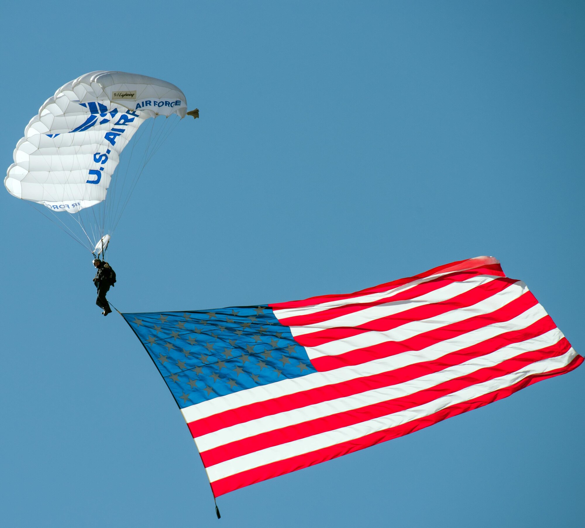 A member of the U.S. Air Force Academy Wings of Blue delivers the American flag during the Wings Over Solano Air Show at Travis Air Force Base, Calif., May 6, 2017. The two-day event featured performances by the U.S. Air Force Thunderbirds aerial demonstration team, flyovers and static displays. (U.S. Air Force photo by Louis Briscese)