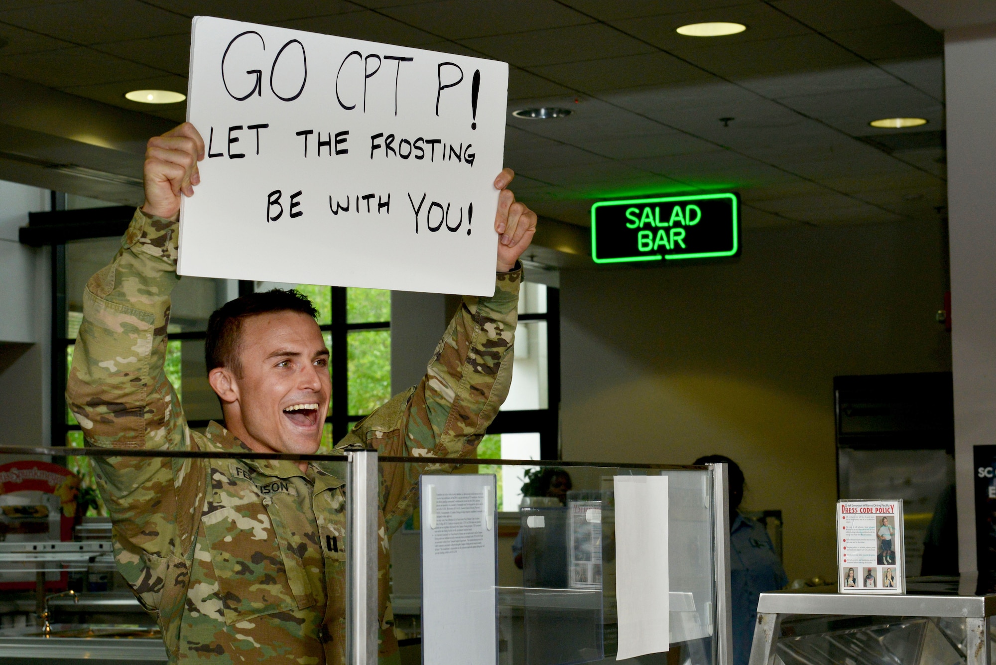 U.S. Army Capt. Scott Ferguson, 20th Operations Support Squadron liaison officer, cheers on participants of the 2017 Cupcake Wars at Shaw Air Force Base, S.C., May 4, 2017. Participants had 90 minutes to bake three different cupcakes for a panel of judges. (U.S. Air Force photo by Airman 1st Class Destinee Sweeney)