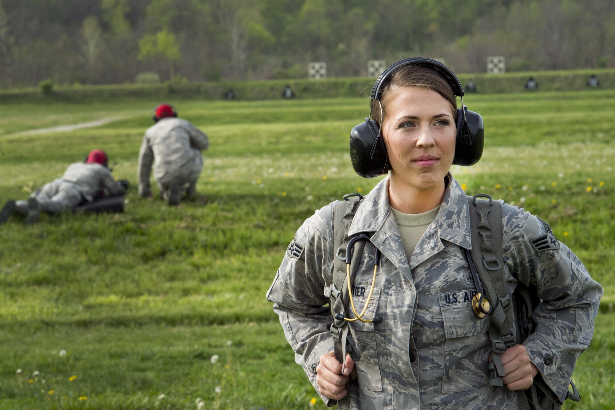 Senior Airman Jayci Cloutier, 434th Aerospace Medicine Squadron medic, poses for a photo at a firing range on Camp Atterburry-Muscatatuck, Indiana, April 20, 2017. Cloutier was the stand-by medical responsible for providing emergency medical care during a 434th Security Forces Training exercise. (U.S. Air Force photo/Senior Airman Cali Wetli)