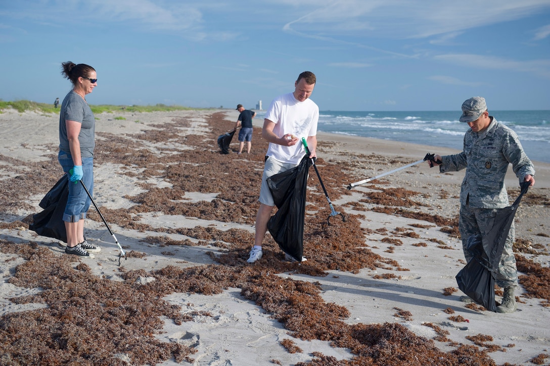 Ericka Barnes, Tech. Sgt. Ryan Bush, and 1st Lt. Joshua Kreimier, of the 45th Space Wing Inspector General’s Office, remove litter from the shoreline as part of Earth Day activities, April 20, 2017, at Cape Canaveral Air Force Station, Fla. The 45th Space Wing celebrated Earth Day with multiple events to include a tree planting ceremony to honor the memory of the late retired Senior Master Sgt. Arthur Fetskos and his many years of service. (U.S. Air Force photo by Matthew Jurgens)    