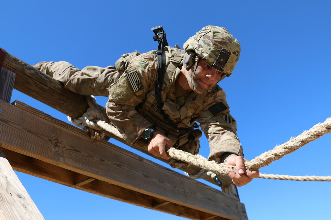 Army Spc. David Mitchell, a cavalry scout with the 3rd Infantry Division squad competing at the Gainey Cup Competition, steadies himself on a rope obstacle during a stress shoot event at Fort Benning, Ga., May 2, 2017. The squad placed second at the 2017 Gainey Cup competition, which showcases competence, physical and mental stamina and competitive reconnaissance. Army photo by Staff Sgt. Candace Mundt