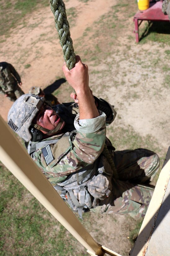 Army Sgt. Evan Gunther, a team leader with the 3rd Infantry Division squad at the Gainey Cup competition, climbs a rope during a stress shoot event at Fort Benning, Ga., May 2, 2017. Army photo by Staff Sgt. Candace Mundt
