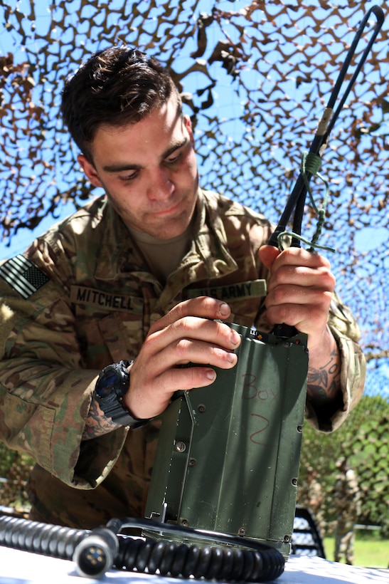 Army Spc. David Mitchell, a cavalry scout with the 3rd Infantry Division's squad at the Gainey Cup competition, assembles a radio  at Fort Benning, Ga., May 3, 2017. Army photo by Staff Sgt. Candace Mundt