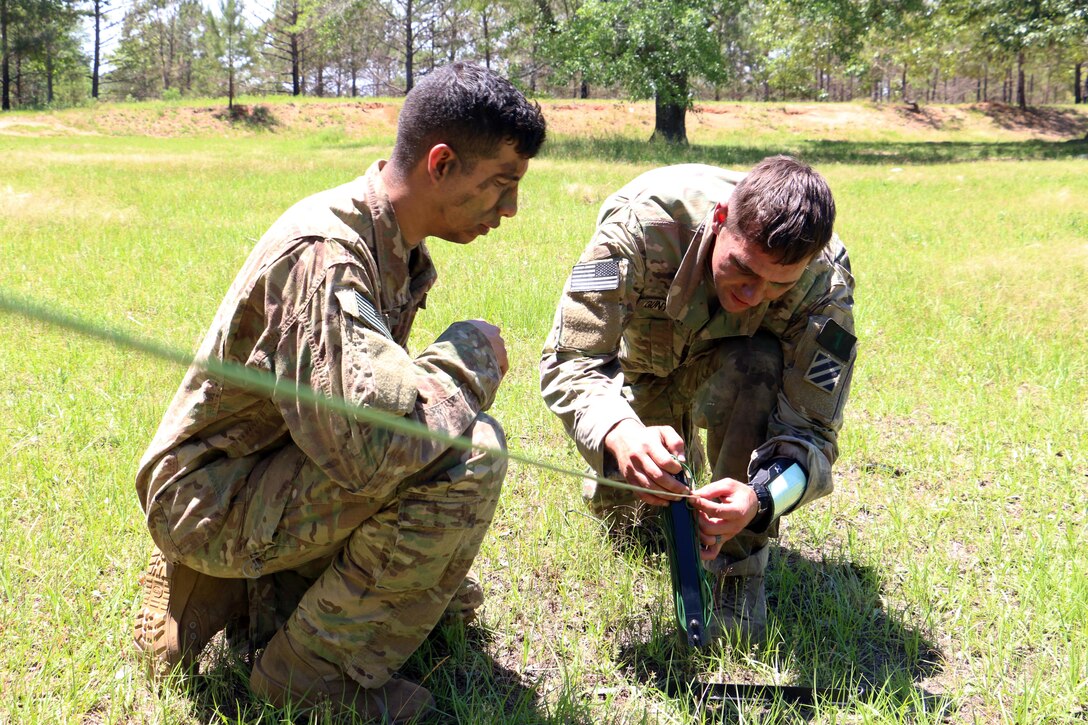 Army Sgt. Evan Gunther, right, places cable for a radio set during the Gainey Cup competition at Fort Benning, Ga., May 3, 2017. The Gainey Cup competition showcases competence, physical and mental stamina, and competitive spirit of reconnaissance of soldiers serving in recon and cavalry formations. Gunther is a team leader assigned to the 3rd Infantry Division's squad at the Gainey Cup competition. Army photo by Staff Sgt. Candace Mundt