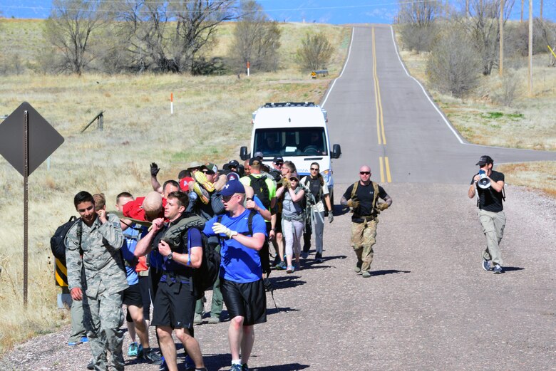 Team Cohesion Challenge participants carry “wounded hostages” to the extraction point at Schriever Air Force Base, Colorado, during the TCC Friday, May 5, 2017. More than 35 Team Schriever members participated in the team-building event. (U.S. Air Force photo/Brian Hagberg)