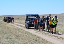 Team Cohesion Challenge participants tow “disabled” vehicles during the TCC at Schriever Air Force Base, Colorado, Friday, May 5, 2017. The vehicle tow was one of several team-building challenges participants completed during the five-hour event. (U.S. Air Force photo/Brian Hagberg)