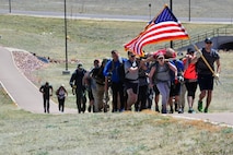 Participants march to the top of the final hill during the Team Cohesion Challenge at Schriever Air Force Base, Colorado, Friday, May 5, 2017. More than 35 Team Schriever members participated in the grueling, five-hour event. (U.S. Air Force photo/Brian Hagberg)