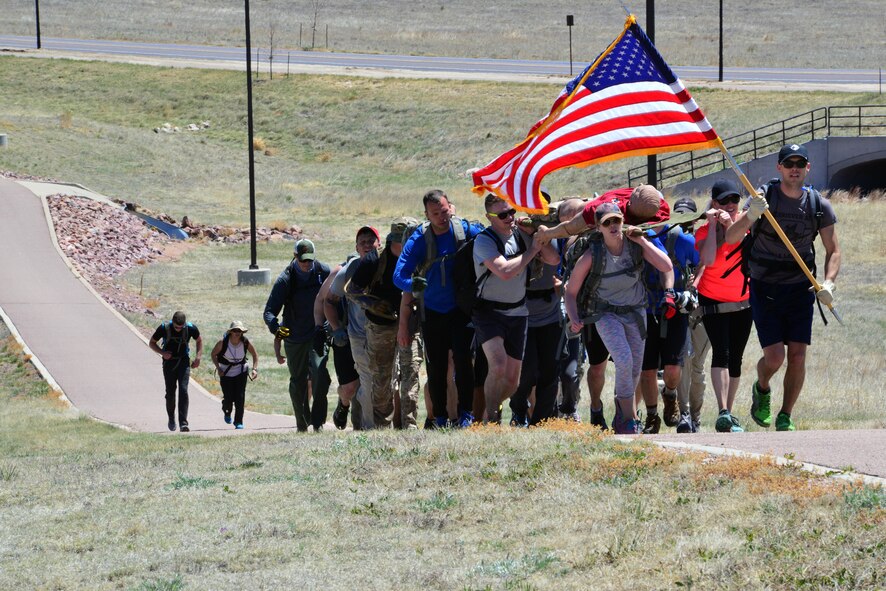 Participants march to the top of the final hill during the Team Cohesion Challenge at Schriever Air Force Base, Colorado, Friday, May 5, 2017. More than 35 Team Schriever members participated in the grueling, five-hour event. (U.S. Air Force photo/Brian Hagberg)
