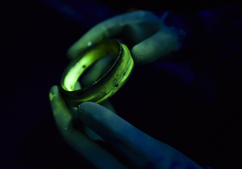 U.S. Air Force Airman 1st Class Lacy Weeks, 1st Maintenance Squadron non-destructive inspection technician, inspects an aircraft part under black light at Joint Base Langley-Eustis, Va., May 4, 2017. The part was dipped in a fluorescent penetrant to show surface defects under black light. (U.S. Air Force photo/Staff Sgt. Natasha Stannard)