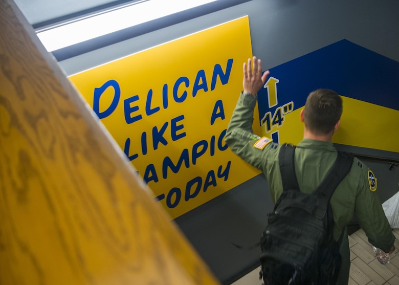 Capt. Keane Carpenter, 14th Airlift Squadron C-17 pilot, touches the Squadron’s “Pelican like a champion today” mural for good luck prior to a training exercise at Joint Base Charleston, S.C., May 5, 2017. Carpenter, along with his crew, dropped a cargo load during the exercise.