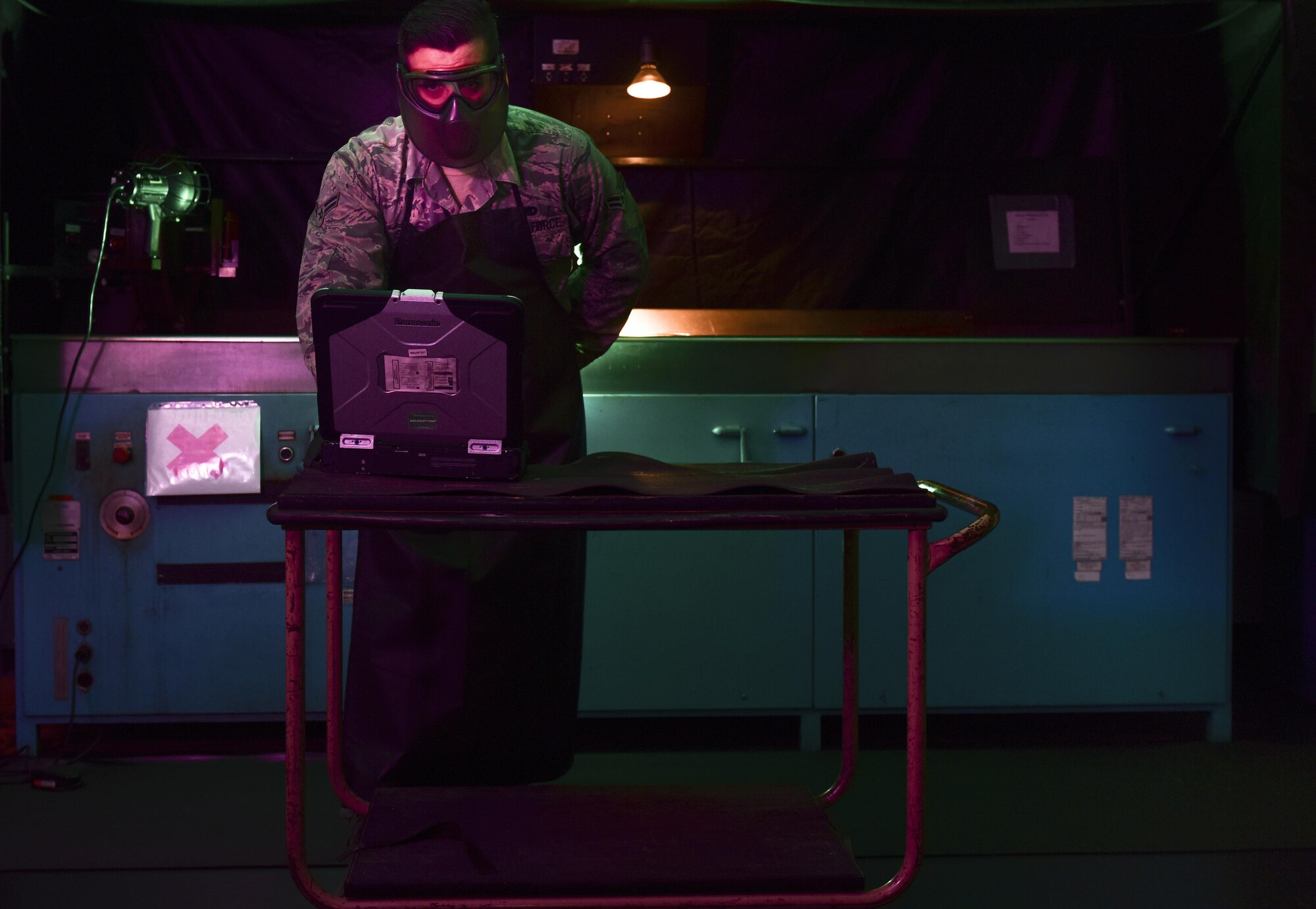 U.S. Air Force Airman 1st Class Dylan Snoddy, 1st Maintenance Squadron non-destructive inspection technician, looks up technical orders for using the magnetic particle unit at Joint Base Langley-Eustis, Va., May 9, 2017. The magnetic particle unit is used to detect faults in ferromagnetic parts that could result in hazards and equipment malfunctions. (U.S. Air Force photo/Staff Sgt. Natasha Stannard)