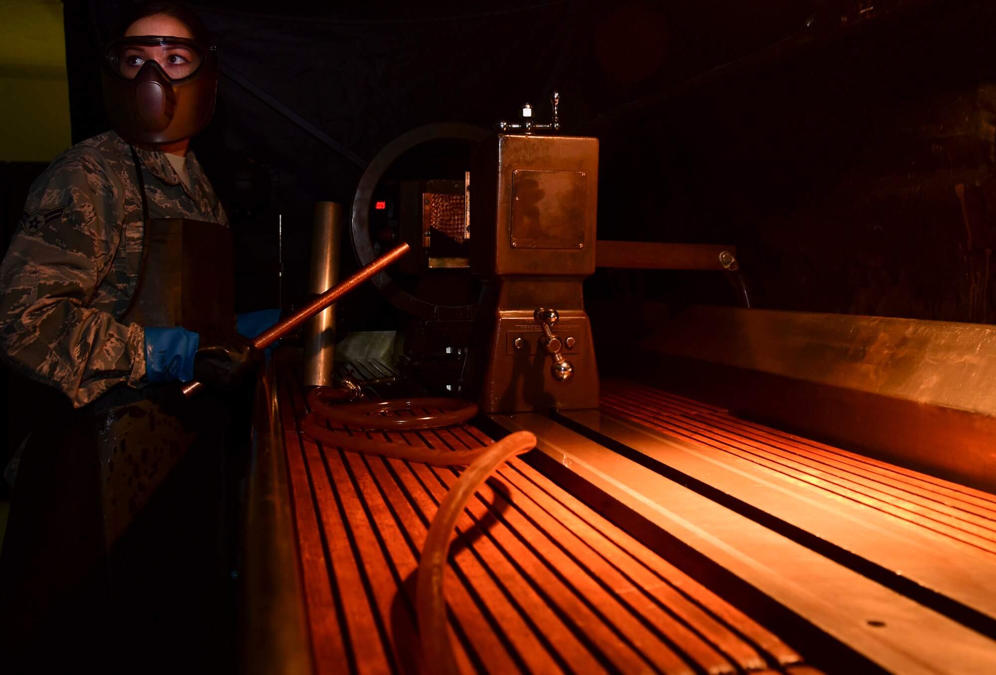 U.S. Air Force Airman 1st Class Lacy Weeks, 1st Maintenance Squadron non-destructive inspection technician, operates a magnetic particle unit used to detect faults in ferromagnetic parts at Joint Base Langley-Eustis, Va., May 4, 2017. When magnetic particles are applied to aircraft parts, the poles attract particles and an indication of a defect is formed. (U.S. Air Force photo/Staff Sgt. Natasha Stannard)