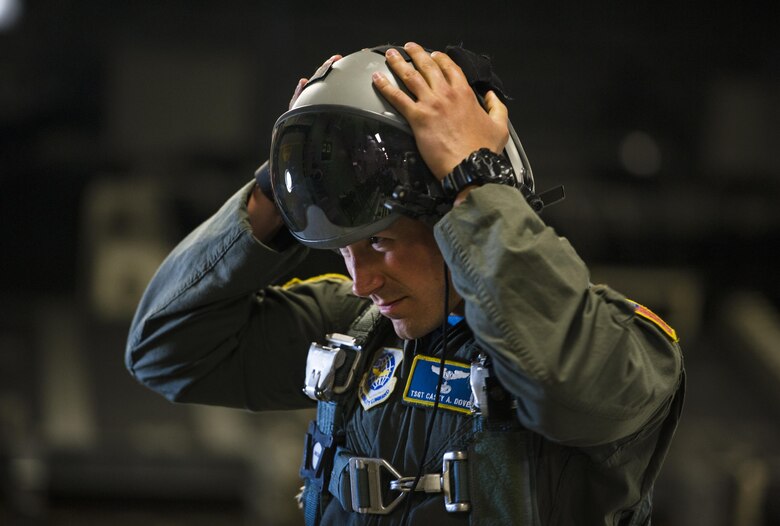 Tech. Sgt. Casey Dover, 14th Airlift Squadron NCO in charge of current operations, puts on his helmet before a flight on a C-17 Globemaster III at Joint Base Charleston, S.C., May 5, 2017. Loadmasters supervise the loading and unloading of cargo, vehicles and people to and from aircraft. 
