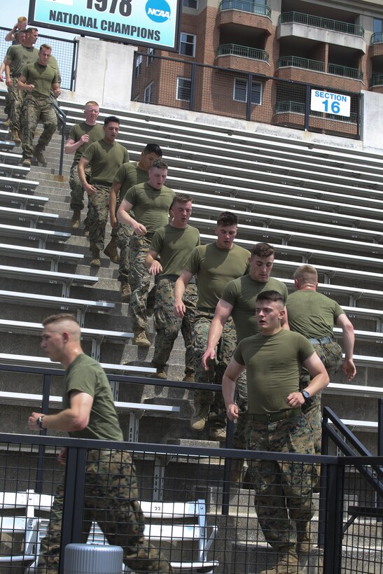 Marines with first platoon, Guard Company, Marine Barracks Washington D.C., executed a "surprise" training regimen at Johns Hopkins University, April 27, 2017. The training promotes team leadership, unit cohesion, and physical endurance. The regimen, designed and executed by the university's Head Strength and Conditioning Coach, Jay Dyer, consists of challenging workouts designed to condition Division One athletes prior to NCAA playoffs and national championships. Upon completion, the Marines were invited to tour the Johns Hopkins Lacrosse facilities in addition to watching the Varsity Men's Lacrosse practice. (Official Marine Corps photo by Lance Cpl. Damon Mclean/Released)