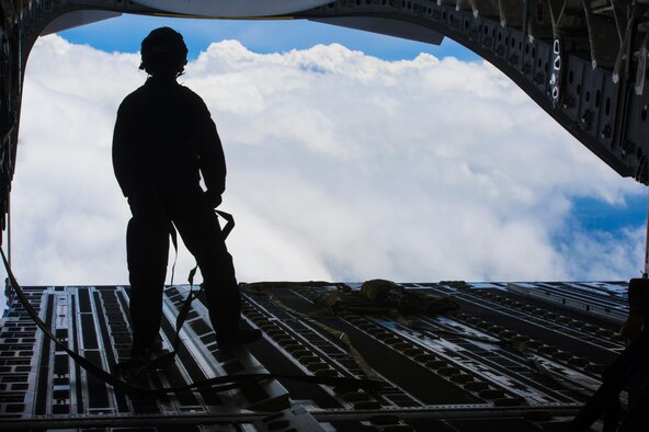 Tech. Sgt. Casey Dover, 14th Airlift Squadron NCO in charge of current operations, looks out of the cargo door of a C-17 Globemaster III before a cargo drop training exercise at Joint Base Charleston, S.C., May 5, 2017. Loadmasters are charged with supervising the loading and unloading of cargo, vehicles and people on aircrafts.