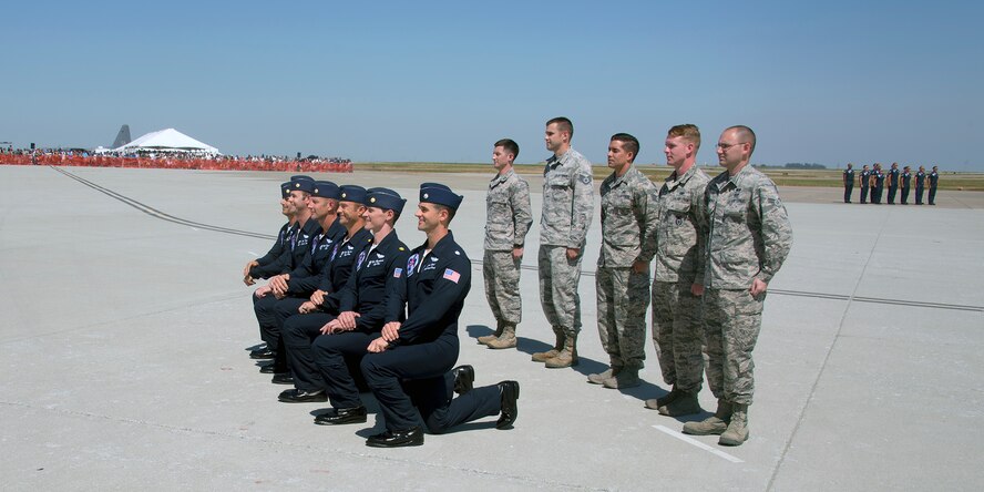Members of the U.S. Air Force Thunderbirds pose for a photo with Airmen from Travis Air Force Base, Calif., during the Wings Over Solano Air Show at Travis May 7, 2017. The two day event featured performances by the Thunderbirds, U.S. Army Golden Knights parachute team, flyovers and static displays. (U.S. Air Force  photo/T.C. Perkins Jr.)
