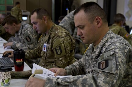 Staff Sgt. Douglas J. McPherson, a U.S. Army Reserve safety officer assigned to Task Force 76 out of  Westover, Mass., updates an operations binder during Vibrant Response 17 at Camp Atterbury, Ind., May 7, 2017. Vibrant Response 17 is an annual command post exercise that simulates the detonation of a nuclear bomb in a major city within the United States. This year it was integrated with Guardian Response 17 at Muscatatuck Urban Training Center, Indiana. The exercises enable emergency response organizations, both civilian and military, to integrate and provide relief during a catastrophic disaster. (U.S. Army Reserve Photo by Sgt. Stephanie Ramirez)