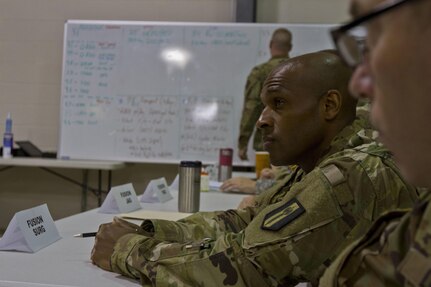 Capt. Antoine Broadnax, a U.S. Army Reserve medical readiness officer assigned to Task Force 76 out of Westover, Mass., expresses Task Force Med. concerns during a battle rhythm brief  for Vibrant Response 17 at Camp Atterbury, Ind., May 7, 2017.  Vibrant Response 17 is an annual command post exercise that simulates the detonation of a nuclear bomb in a major city within the United States. This year it was integrated with Guardian Response 17 at Muscatatuck Urban Training Center, Indiana. The exercises enable emergency response organizations, both civilian and military, to integrate and provide relief during a catastrophic disaster. (U.S. Army Reserve Photo by Sgt. Stephanie Ramirez)