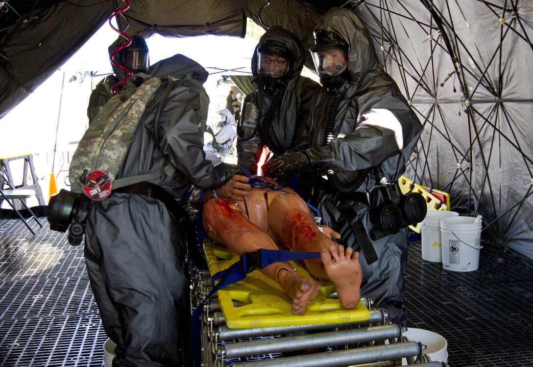 U.S. Army Reserve Soldiers assigned to the 414th chemical, biological, radiological, nuclear and explosives (CBRNE) Company out of Orangeburg, S.C., decontaminate casualties after a simulated nuclear bomb explosion during Vibrant Response 17 at Camp Atterbury, Ind., May 7, 2017.  The 414th CBRNE Company is assigned to Task Force 76 as one of their decontamination units. Vibrant Response 17 is an annual command post exercise that simulates the detonation of a nuclear bomb in a major city within the United States. This year it was integrated with Guardian Response 17 at Muscatatuck Urban Training Center, Indiana. The exercises enable emergency response organizations, both civilian and military, to integrate and provide relief during a catastrophic disaster. (U.S. Army Reserve Photo by Sgt. Stephanie Ramirez)