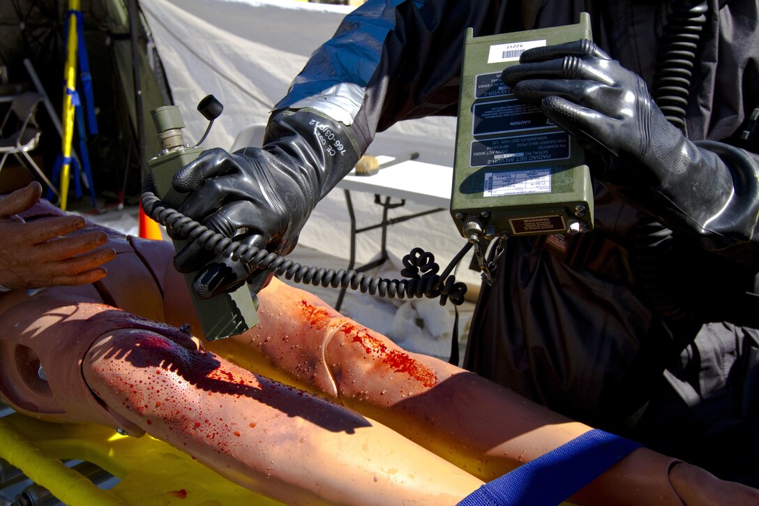 A U.S. Army Reserve Soldier assigned to the 414th chemical, biological, radiological, nuclear and explosives (CBRNE) Company out of Orangeburg, S.C., checks radiation levels on a casualty after a simulated nuclear bomb explosion during Vibrant Response 17 at Camp Atterbury, Ind., May 7, 2017.  The 414th CBRNE Company is assigned to Task Force 76 as one of their decontamination units.  The 414th CBRNE Company is assigned to Task Force 76 as one of their decontamination units. Vibrant Response 17 is an annual command post exercise that simulates the detonation of a nuclear bomb in a major city within the United States. This year it was integrated with Guardian Response 17 at Muscatatuck Urban Training Center, Indiana. The exercises enable emergency response organizations, both civilian and military, to integrate and provide relief during a catastrophic disaster. (U.S. Army Reserve Photo by Sgt. Stephanie Ramirez)