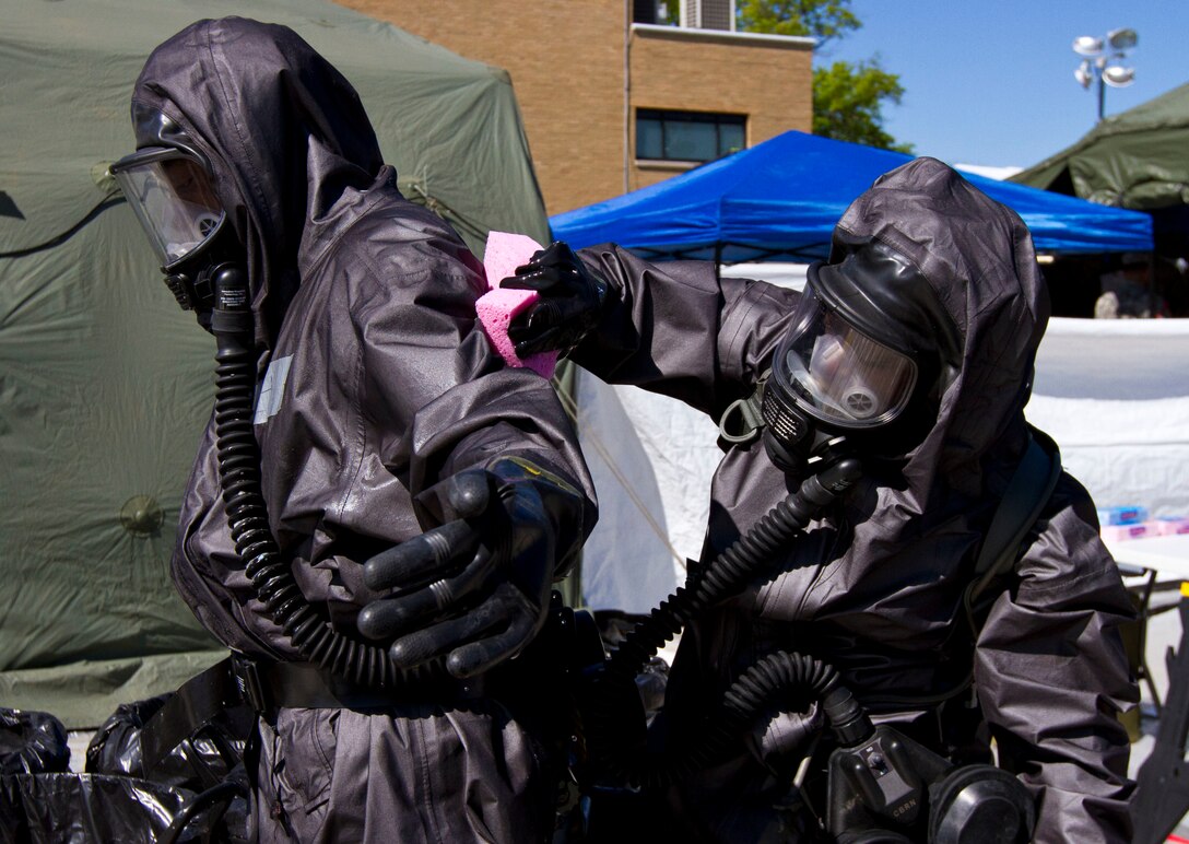 U.S. Army Reserve Soldiers assigned to the 414th chemical, biological, radiological, nuclear and explosives (CBRNE) Company out of Orangeburg, S.C., decontaminate each other after a simulated nuclear bomb explosion during Vibrant Response 17 at Camp Atterbury, Ind., May 7, 2017.  The 414th CBRNE Company is assigned to Task Force 76 as one of their decontamination units. Vibrant Response 17 is an annual command post exercise that simulates the detonation of a nuclear bomb in a major city within the United States. This year it was integrated with Guardian Response 17 at Muscatatuck Urban Training Center, Indiana. The exercises enable emergency response organizations, both civilian and military, to integrate and provide relief during a catastrophic disaster. (U.S. Army Reserve Photo by Sgt. Stephanie Ramirez)