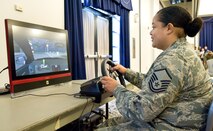 Master Sgt. Chandra Hines, 436th Aerospace Medicine Squadron, drives a vehicle simulator May 5, 2017, at The Landings on Dover Air Force Base, Del. At Dover’s Wingman University “You booze, you cruise, you lose” activity, Hines and other Team Dover members attempted to navigate a vehicle through a road course that simulated driving under the influence. (U.S. Air Force photo by Roland Balik)