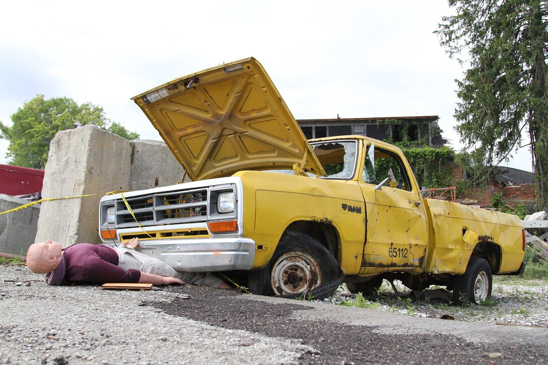 A mannequin victim awaiting rescue is pinned underneath a vehicle May 6, 2017, at Muscatatuck Urban Training Center, Indiana, during Guardian Response 17. Nearly 4,100 Soldiers from across the country are participating in Guardian Response 17, a multi-component training exercise to validate U.S. Army units' ability to support the Defense Support of Civil Authorities (DSCA) in the event of a Chemical, Biological, Radiological, and Nuclear (CBRN) catastrophe.