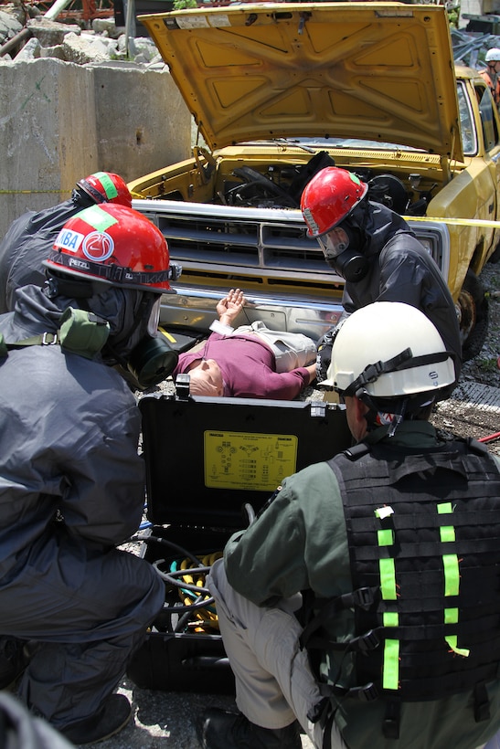 U.S. Army Reserve Soldiers prepare to extract a mannequin victim from underneath a vehicle May 6, 2017 at Muscatatuck Urban Training Center, Indiana. Nearly 4,100 Soldiers from across the country are participating in Guardian Response 17, a multi-component training exercise to validate U.S. Army units' ability to support the Defense Support of Civil Authorities (DSCA) in the event of a Chemical, Biological, Radiological, and Nuclear (CBRN) catastrophe.