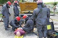 United States Army Reserve Soldiers from Danvers, Massachusetts, based 468th Engineer Detachment treat a mannequin victim extracted from underneath a vehicle May 6, 2017 at Muscatatuck Urban Training Center, Indiana. Nearly 4,100 Soldiers from across the country are participating in Guardian Response 17, a multi-component training exercise to validate U.S. Army units' ability to support the Defense Support of Civil Authorities (DSCA) in the event of a Chemical, Biological, Radiological, and Nuclear (CBRN) catastrophe.