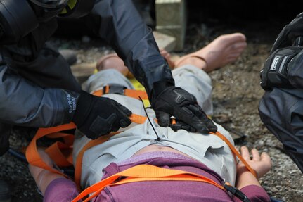 A U.S. Army Reserve Soldier secures the gurney straps on a mannequin victim extracted from underneath a vehicle May 6, 2017 at Muscatatuck Urban Training Center, Indiana. Nearly 4,100 Soldiers from across the country are participating in Guardian Response 17, a multi-component training exercise to validate U.S. Army units' ability to support the Defense Support of Civil Authorities (DSCA) in the event of a Chemical, Biological, Radiological, and Nuclear (CBRN) catastrophe.