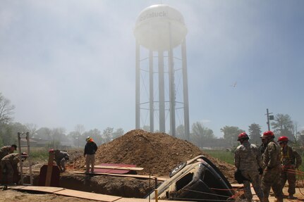 During a specialized form of rescue, Soldiers of the 468th Fire Fighting Detachment engage in one of the most dangerous rescue operations to complete during Guardian Response 17 at Muscatatuck Urban Training Center, Indiana on May 7, 2017.

Nearly 5,000 Soldiers and Airmen from across the country are participating in Guardian Response 17, a multi-component training exercise to validate the military's ability to support Civil Authorities in the event of a Chemical, Biological, Radiological, and Nuclear (CBRN) catastrophe. (U.S. Army Reserve photo by Staff Sgt. Christopher Sofia/Released)