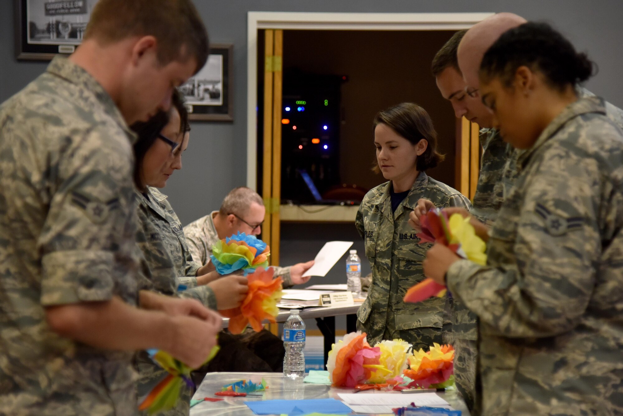 U.S. Air Force Tech. Sgt. Cheyanne Samples, 315th Training Squadron instructor, watches Airmen make paper flowers for the Top Tech competition at the Event Center on Goodfellow Air Force Base, Texas, May 5, 2017. Samples taught the Airmen the skills needed to make flowers without assistance. During the competition, instructors had to teach a subject and audience members had to demonstrate their understanding of the topic. (U.S. Air Force photo by Staff Sgt. Joshua Edwards/Released)
