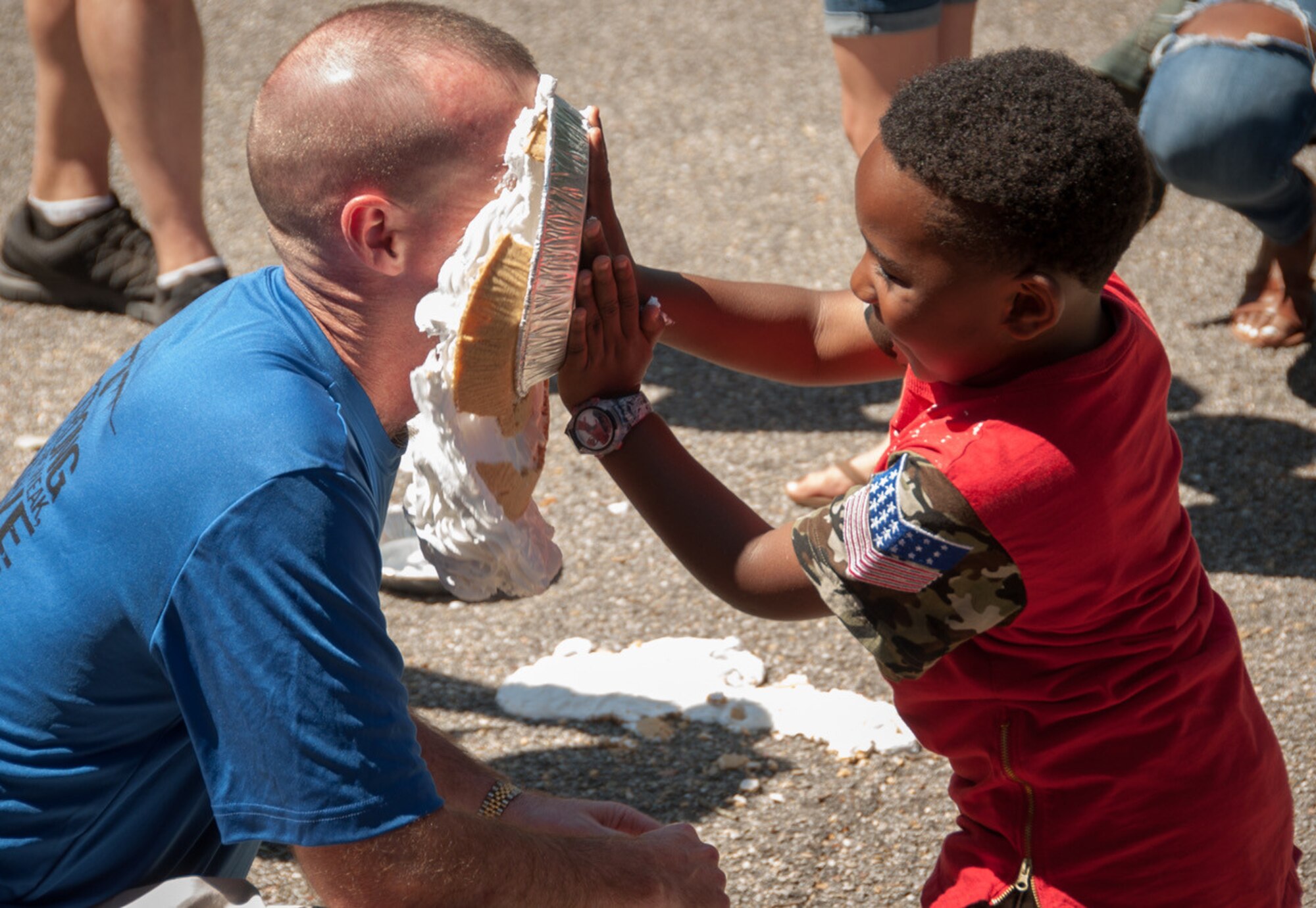 Tyler Ingel, 403rd Wing family member pies Col. Chad Segura, 403rd Mission Support Group commander, in the face during the annual 403rd Wing Airman and Family Day picnic May 6, 2017 at Keesler Air Force Base, Mississippi. (U.S. Air Force photo/Staff Sgt. Shelton Sherrill) 