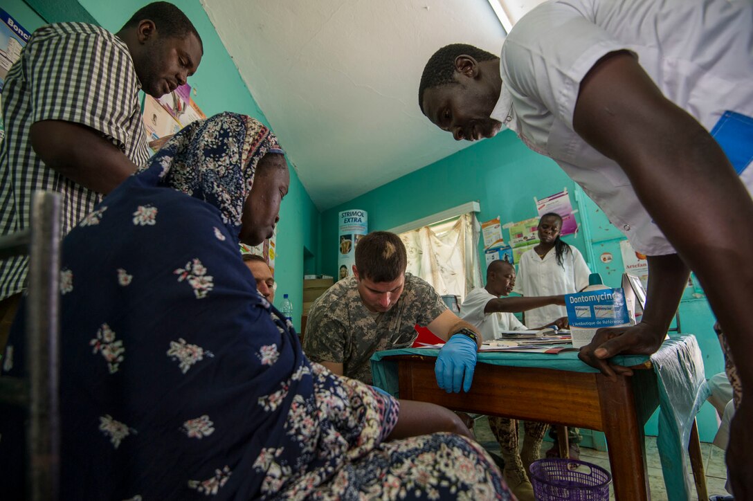 Chadian and U.S. Army military medical professionals examine a patient together in the clinic during Medical Readiness Training Exercise 17-3 at the Military Teaching Hospital in N'Djamena, Chad, May 5. The mutually beneficial exercise offers opportunities for the partnered militaries to share best practices and improve medical treatment processes. (U.S. Army Africa photo by Staff Sgt. Shejal Pulivarti)