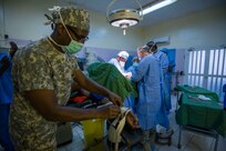 U.S. Army Reserve Maj. Christopher Sims, a nurse anesthetist, assigned to 3rd Medical Command Deployment Support in Forest Park, Ga., fastens arm guards on a surgical patient during Medical Readiness Training Exercise 17-3 at the Military Teaching Hospital in N'Djamena, Chad, May 8. The mutually beneficial exercise offers opportunities for the partnered militaries to share best practices and improve medical treatment processes. (U.S. Army Africa photo by Staff Sgt. Shejal Pulivarti)