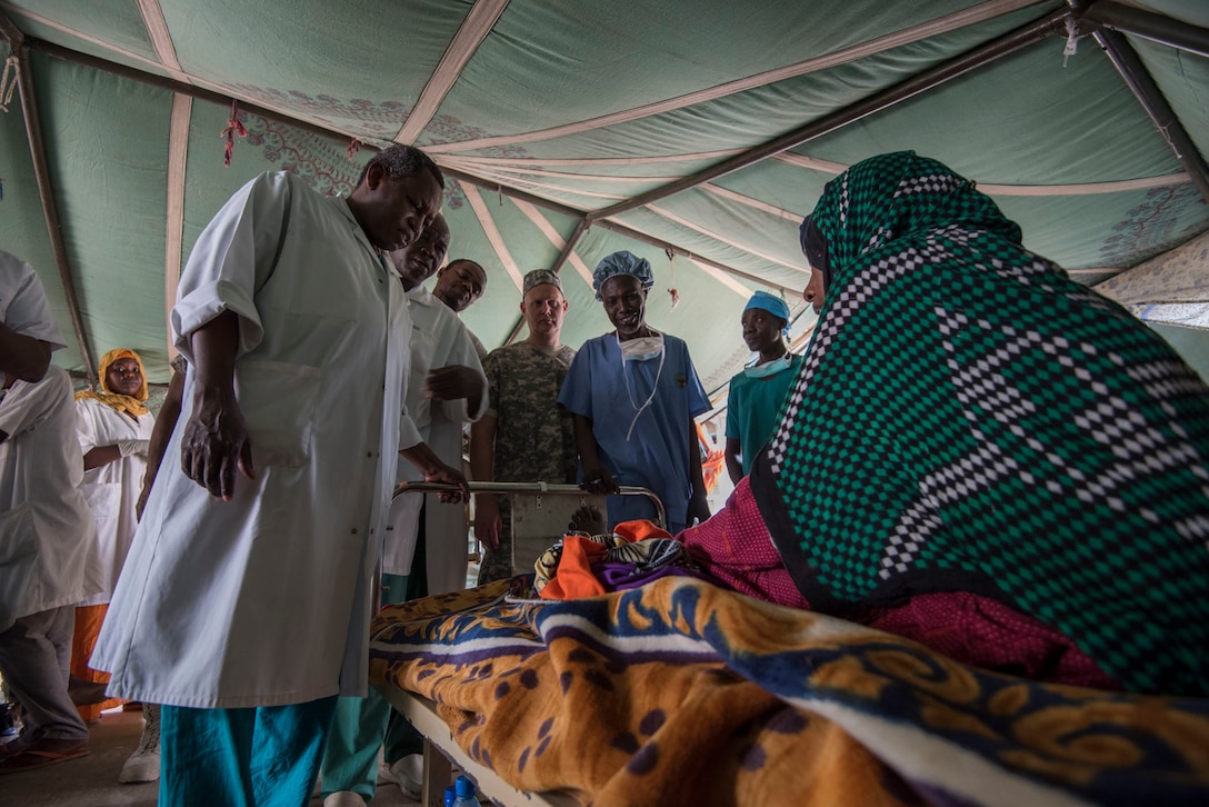 Chadian and U.S. Army military medical professionals perform post-operative rounds to assess patient progress during Medical Readiness Training Exercise 17-3 at the Military Teaching Hospital in N'Djamena, Chad, May 8. The mutually beneficial exercise offers opportunities for the partnered militaries to share best practices and improve medical treatment processes. (U.S. Army Africa photo by Staff Sgt. Shejal Pulivarti)