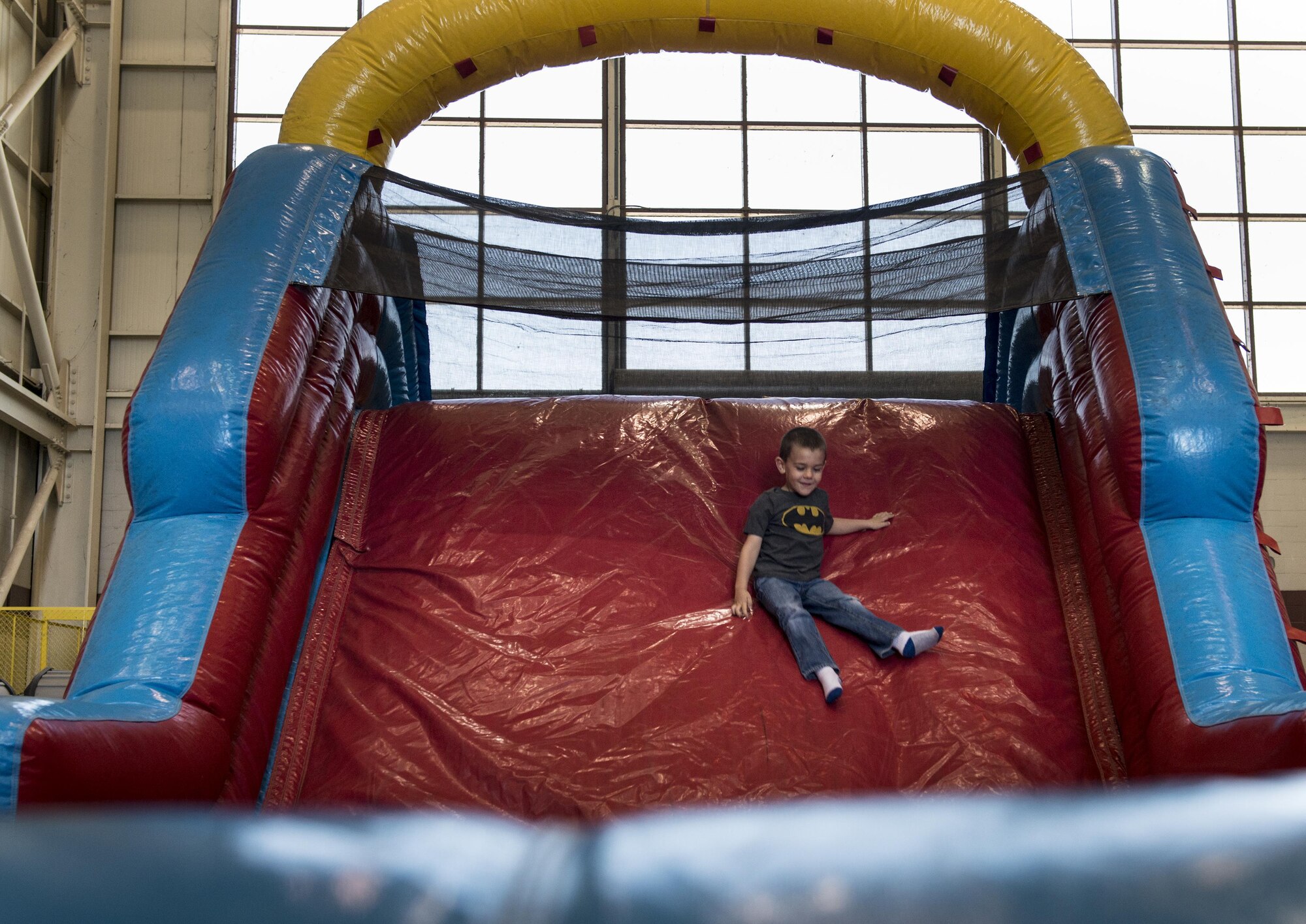 A child enjoys playing in the Playzone during the Wings Over Solano Air Show at Travis Air Force Base Calif., May 7, 2017. The event featured performances from the U.S. Air Force Thunderbirds Aerial Demonstration Team, U.S. Army Golden Knights parachute teams and civilian perfomers. (U.S. Air Force photo by Heide Couch)