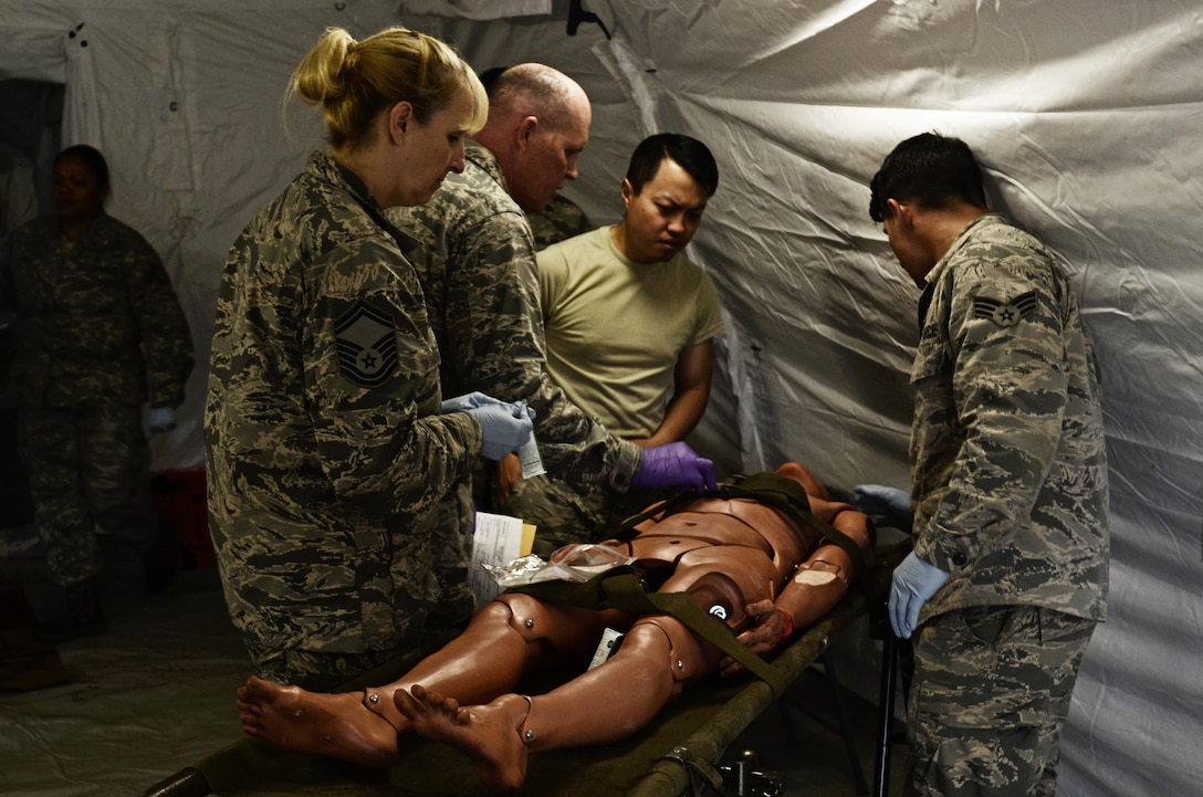 U.S. Army Reserve Soldiers, assigned to the 469th Medical Company-Ground Ambulance out of Wichita, Kansas, and Air Men, assigned to the 6th Medical Operations Squadron out of MacDill Air Force Base in Tampa, Fl., transport casualties from the point of drop off to the Air Force expeditionary medical support tent at forward operating base Nighthawk in Camp Atterbury, In., April 29, 2017, as part of Exercise Guardian Response. Nearly 4,100 Soldiers from across the country are participating in Guardian Response 17, a multi-component training exercise to validate U.S. Army units’ ability to support the Defense Support of Civil Authorities (DSCA) in the event of a Chemical, Biological, Radiological, and Nuclear (CBRN) catastrophe. The 84th Training Command is the hosting organization for this exercise, with the training operations run by the 78th Training Division, headquartered in Fort Dix, New Jersey. (U.S. Army Reserve photo by Capt. Loyal Auterson)