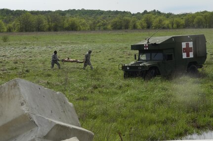 U.S. Army Reserve Soldiers, assigned to the 469th Medical Company-Ground Ambulance out of Wichita, Kansas, and Air Men, assigned to the 6th Medical Operations Squadron out of MacDill Air Force Base in Tampa, Fl., transport casualties from the point of drop off to the Air Force expeditionary medical support tent at forward operating base Nighthawk in Camp Atterbury, In., April 29, 2017, as part of Exercise Guardian Response. Nearly 4,100 Soldiers from across the country are participating in Guardian Response 17, a multi-component training exercise to validate U.S. Army units’ ability to support the Defense Support of Civil Authorities (DSCA) in the event of a Chemical, Biological, Radiological, and Nuclear (CBRN) catastrophe. The 84th Training Command is the hosting organization for this exercise, with the training operations run by the 78th Training Division, headquartered in Fort Dix, New Jersey. (U.S. Army Reserve photo by Capt. Loyal Auterson)